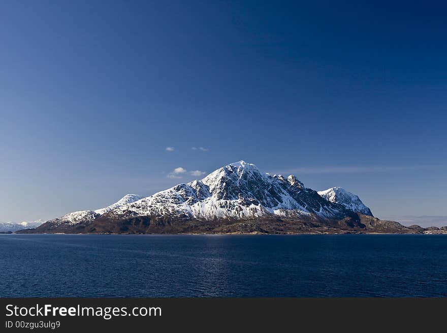 Snow-covered mountains at the Arctic ocean. Snow-covered mountains at the Arctic ocean