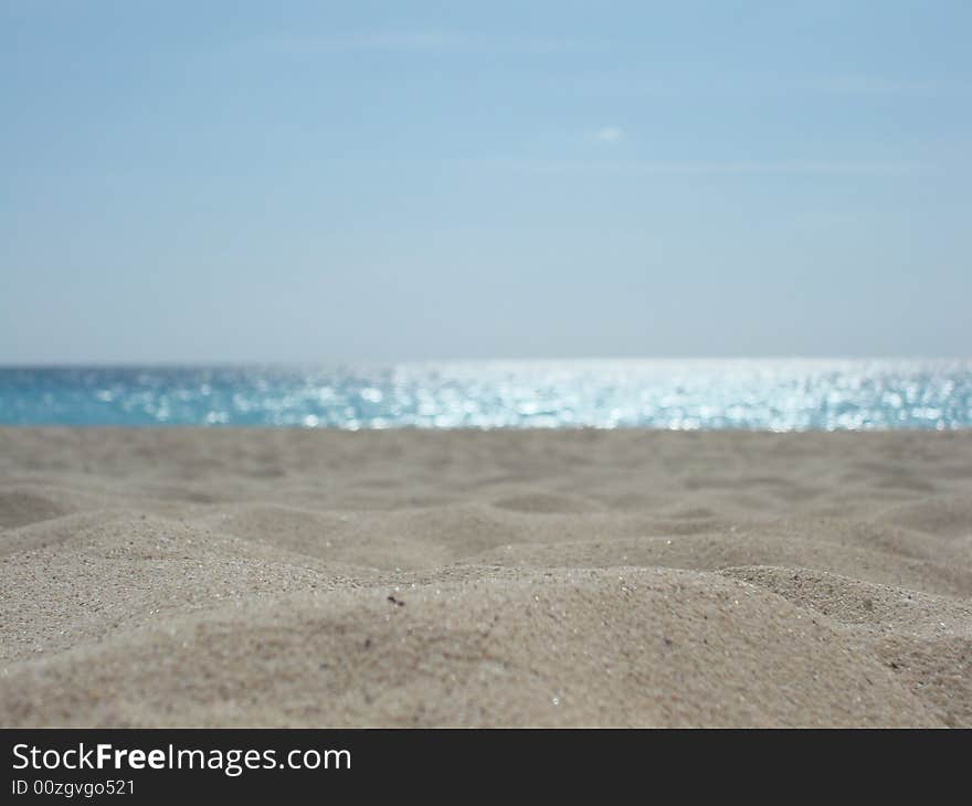 Microdunes over the beach of cancun backgrounded by the multi blue caribbean ocean