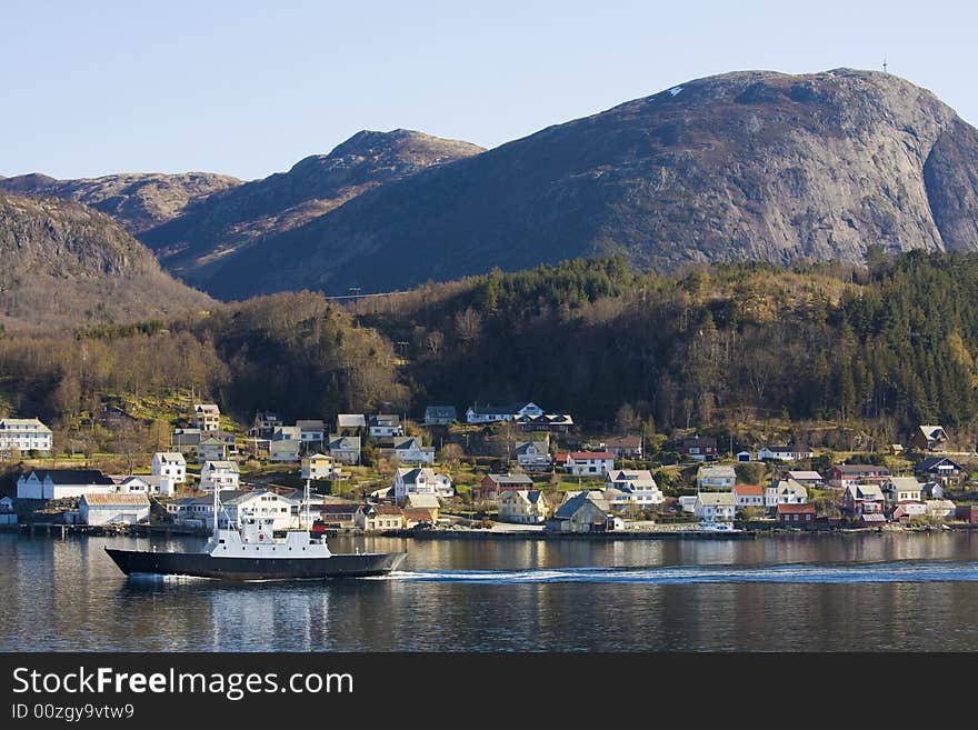 Coastal village in Norway, ferry in the foreground