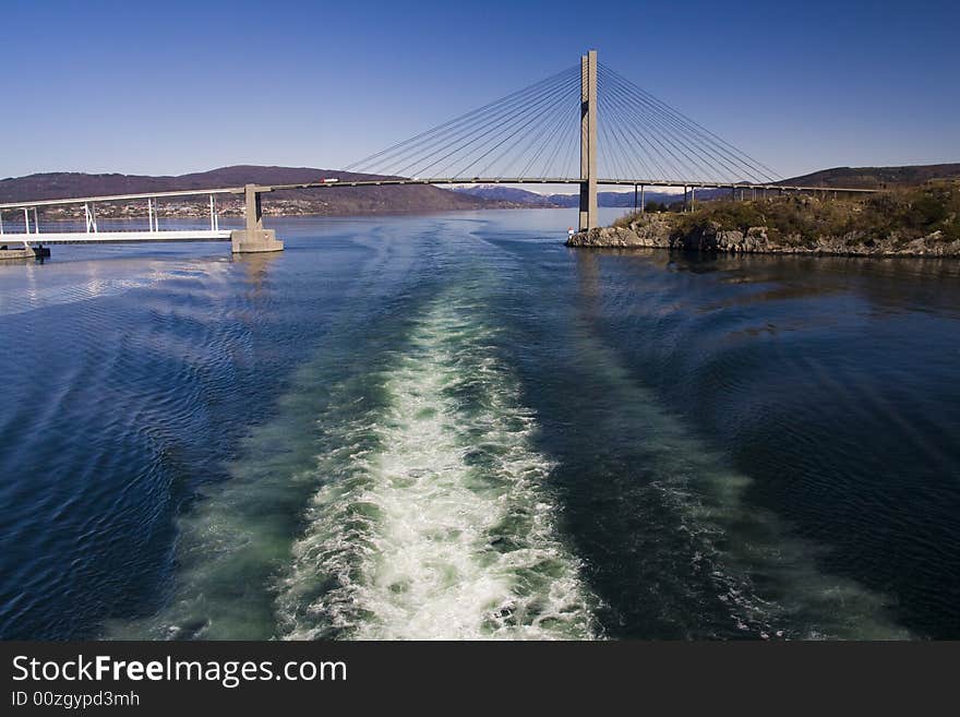 Ship drives through under a bridge. Ship drives through under a bridge