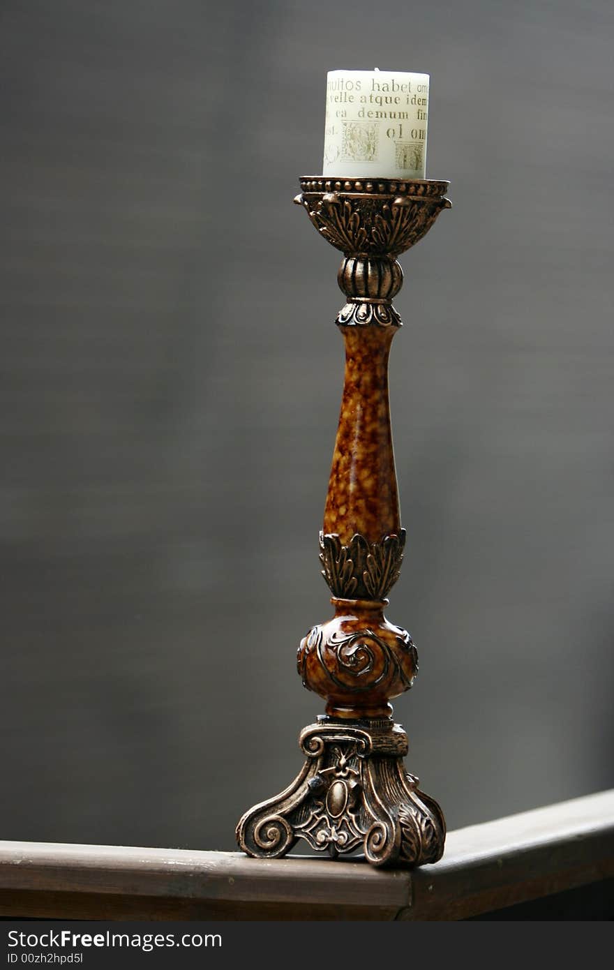 Antique wooden candlestick isolated on grey background