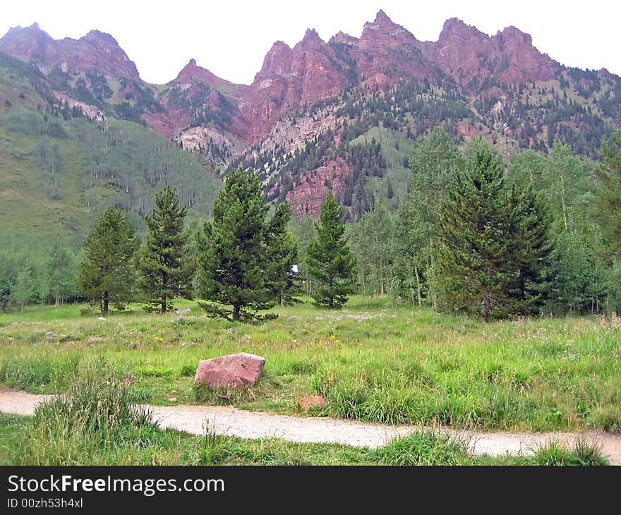 Path next to jagged Rocky Mountain peaks. Path next to jagged Rocky Mountain peaks.