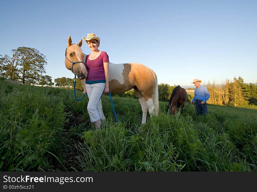 Female Farmer Smiling With Horse - Horizontal