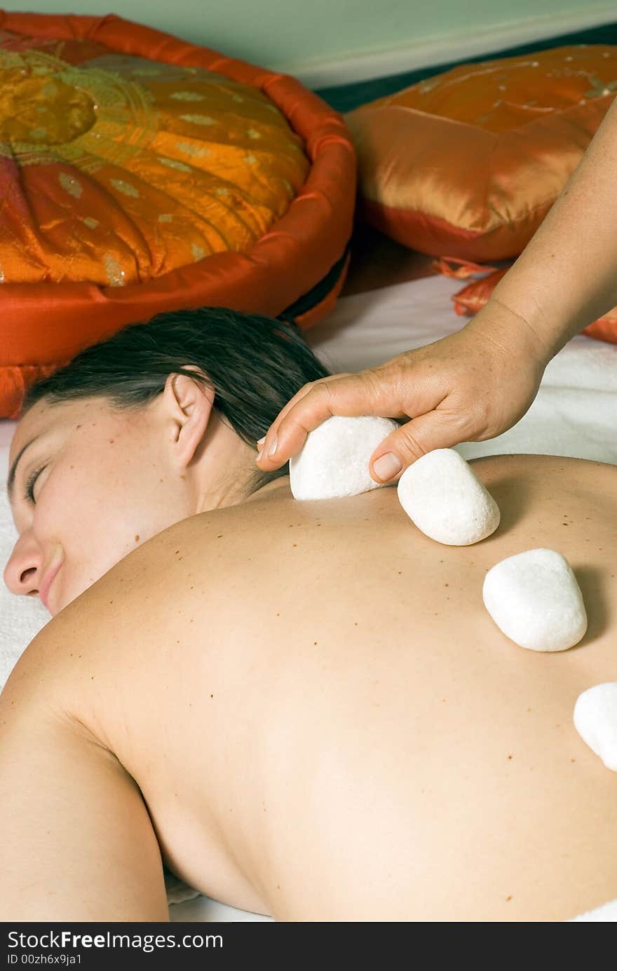 Girl Smiles as Rocks are Put on her Back- vertical