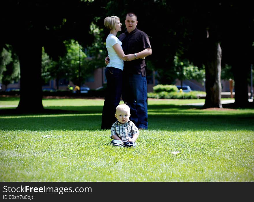 Baby Laughing While Parents Hug - Horizontal