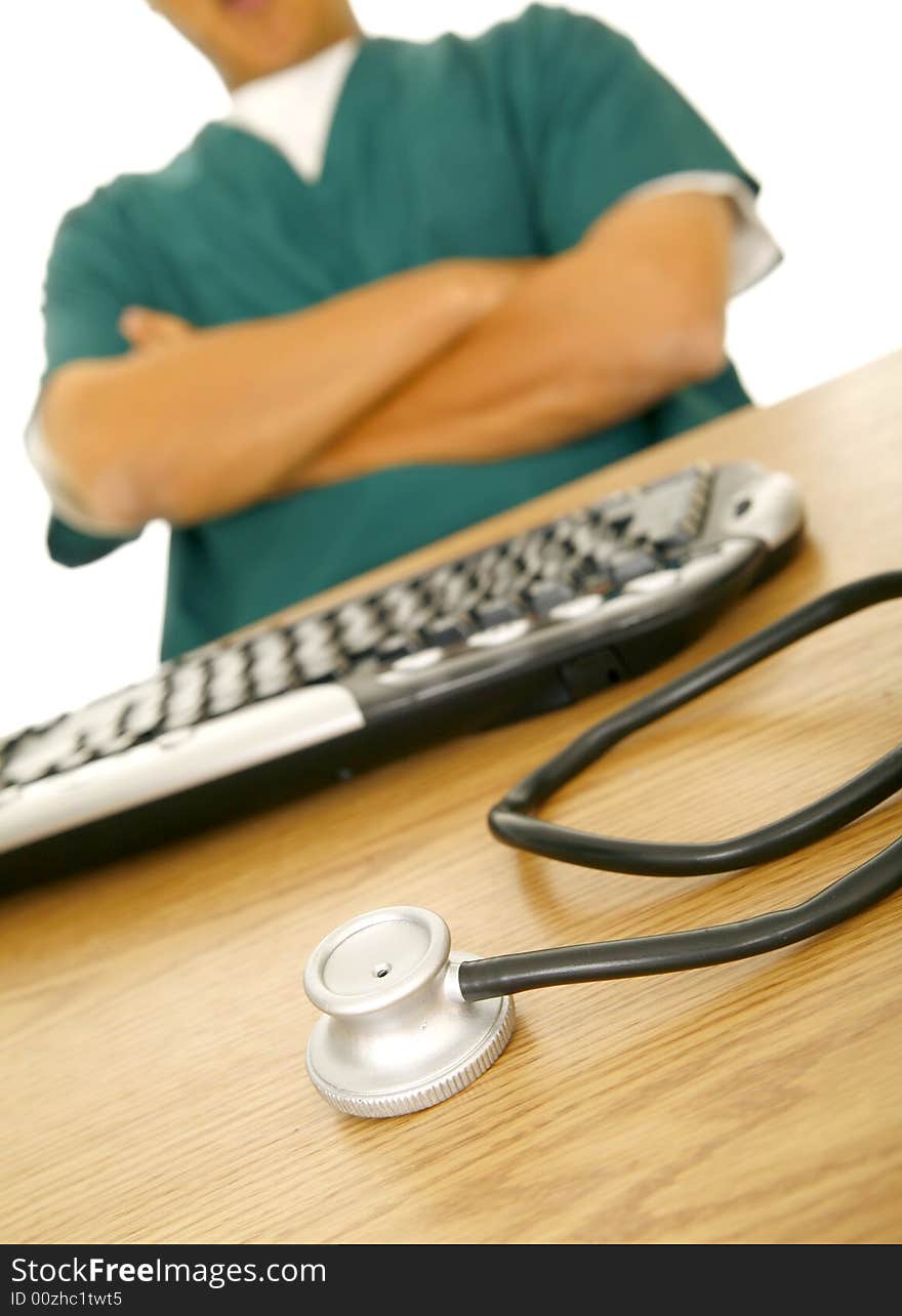 Close up of stethoscope sit on nurse or doctor's table. there is man in medical uniform on the background. Close up of stethoscope sit on nurse or doctor's table. there is man in medical uniform on the background