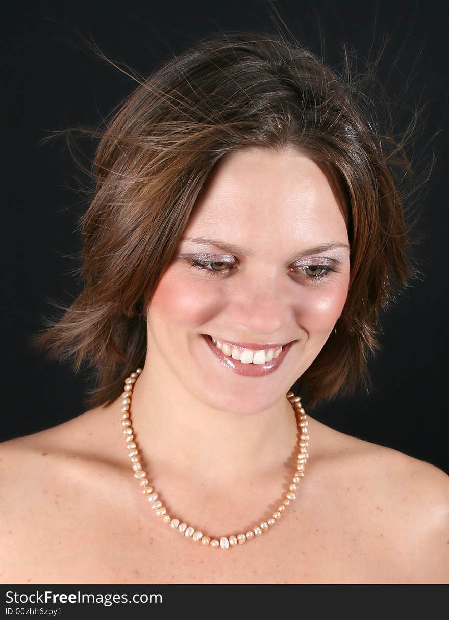 Beautiful young woman with bare shoulders and pearls. Beautiful young woman with bare shoulders and pearls