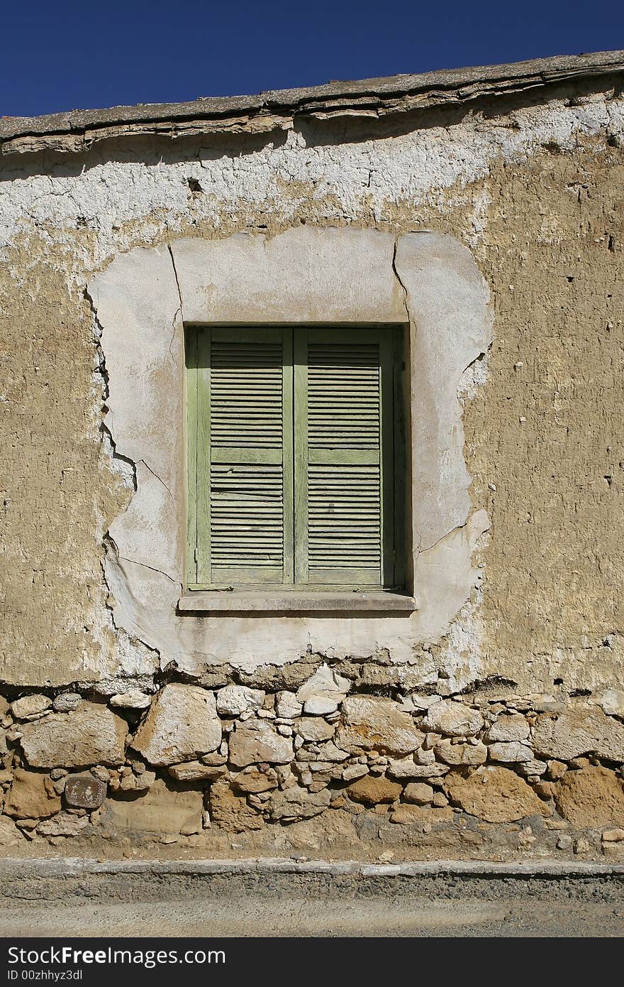 A green wooden window in a stone wall. A green wooden window in a stone wall