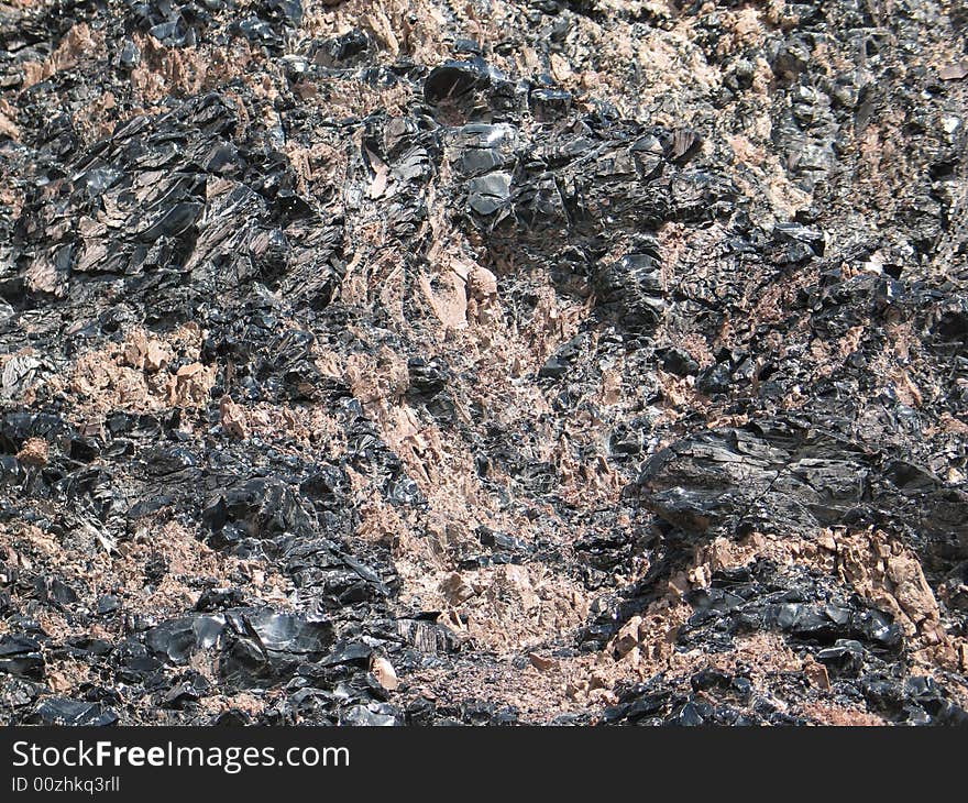 Obsidian mixed with other concretes, natural texture background. Obsidian mixed with other concretes, natural texture background