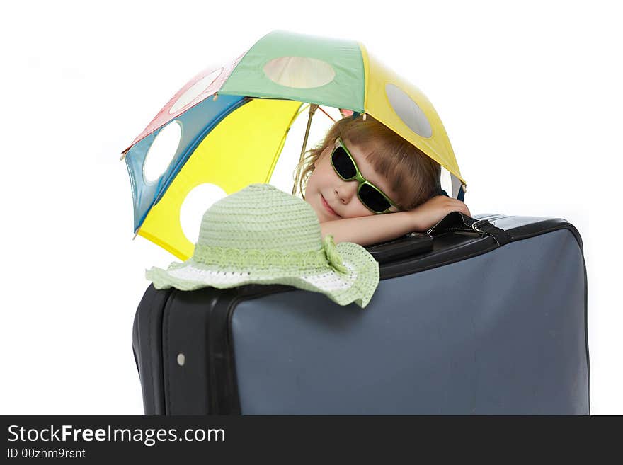 Nice  girl with umbrella on a valise. Nice  girl with umbrella on a valise