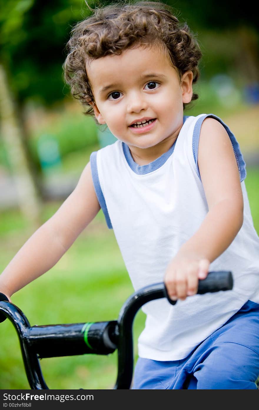 A young boy on his first bike in the park. A young boy on his first bike in the park