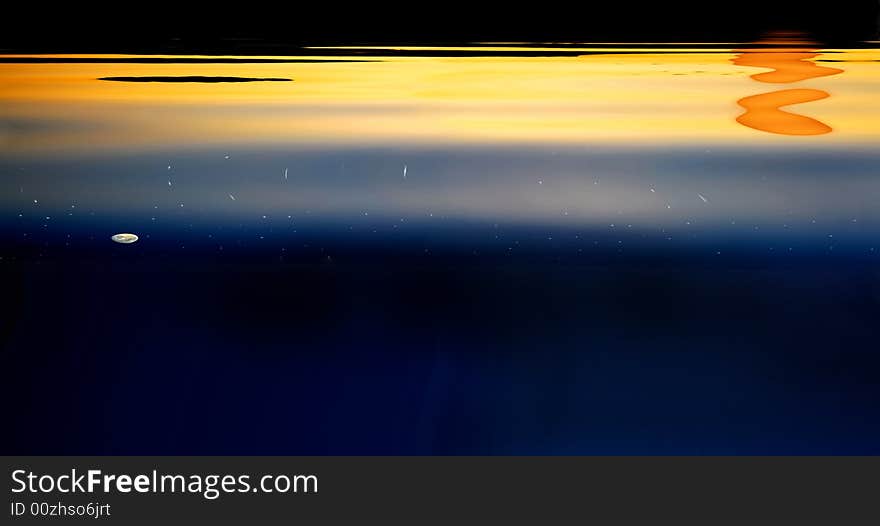 Moon and Stars shine before sun goes down on water reflection. Moon and Stars shine before sun goes down on water reflection