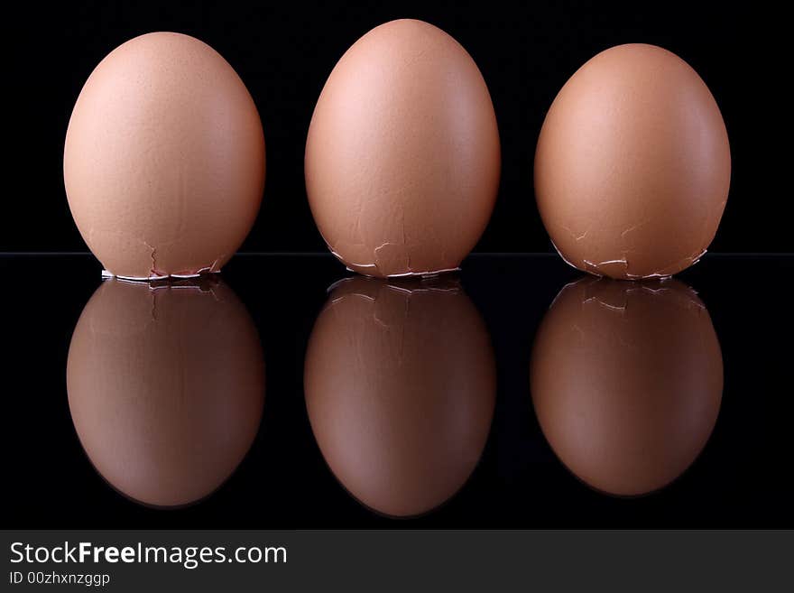 Three eggs on black background