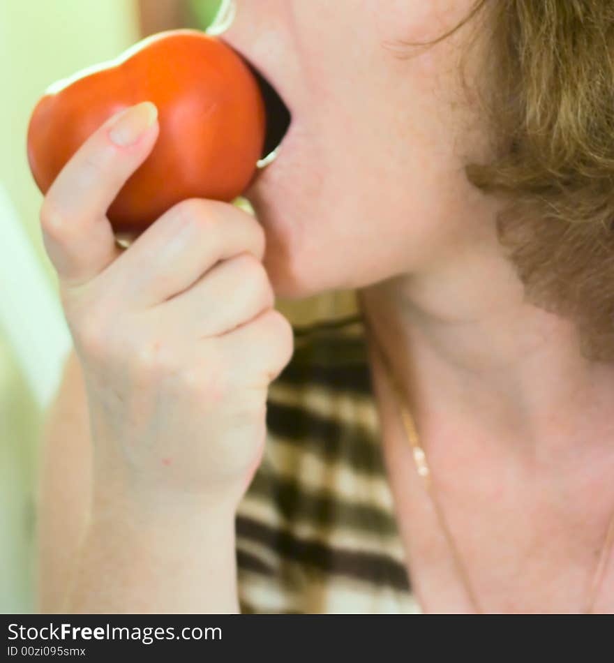 Woman eating tomato for your design