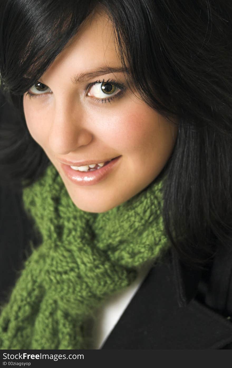 Dark haired young woman wearing a green scarf and black blazer. Dark haired young woman wearing a green scarf and black blazer