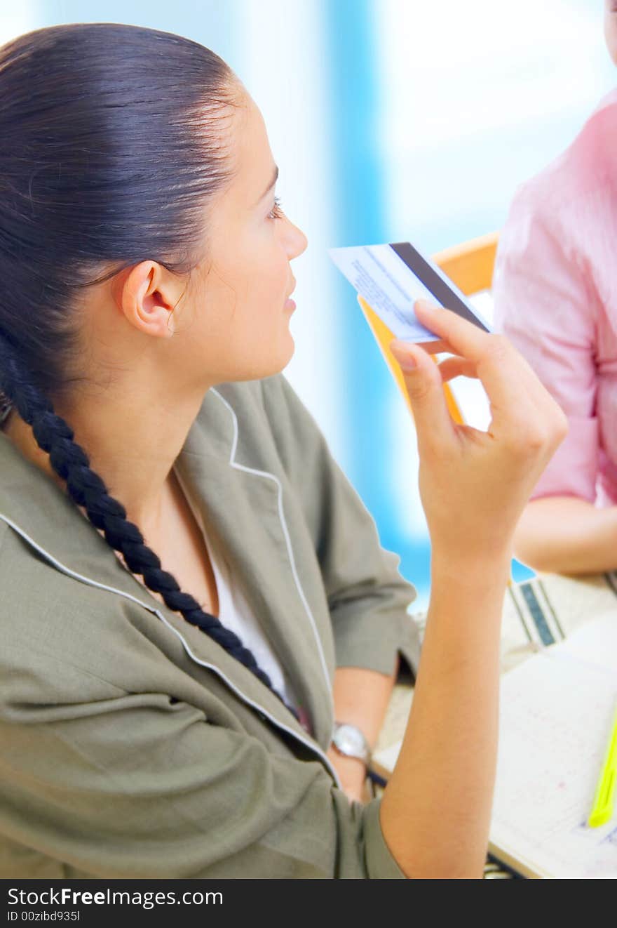 Two young businesswomen reading message on coffee break, outdoors. Two young businesswomen reading message on coffee break, outdoors