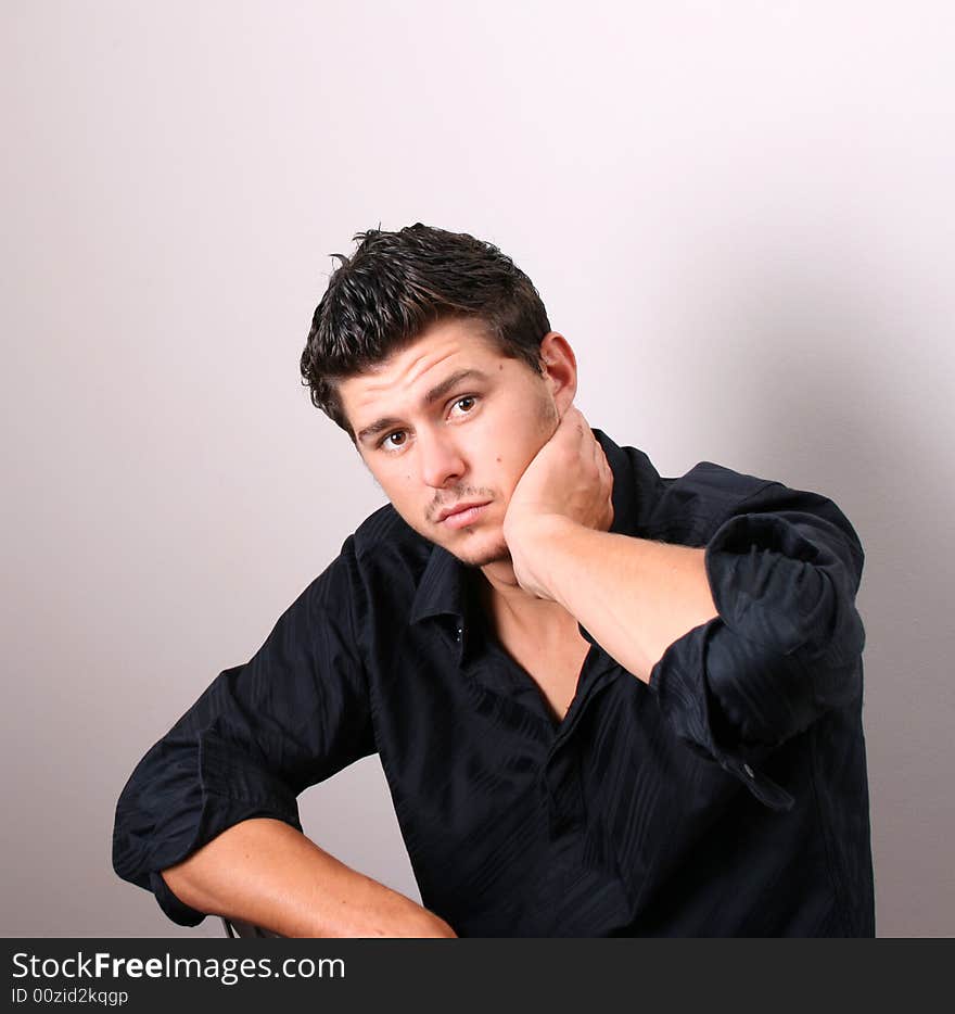 Male model in studio against white wall