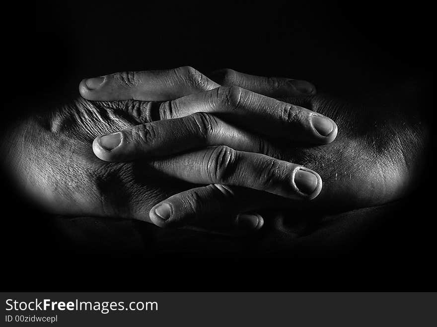 Close-up hands of the man over black