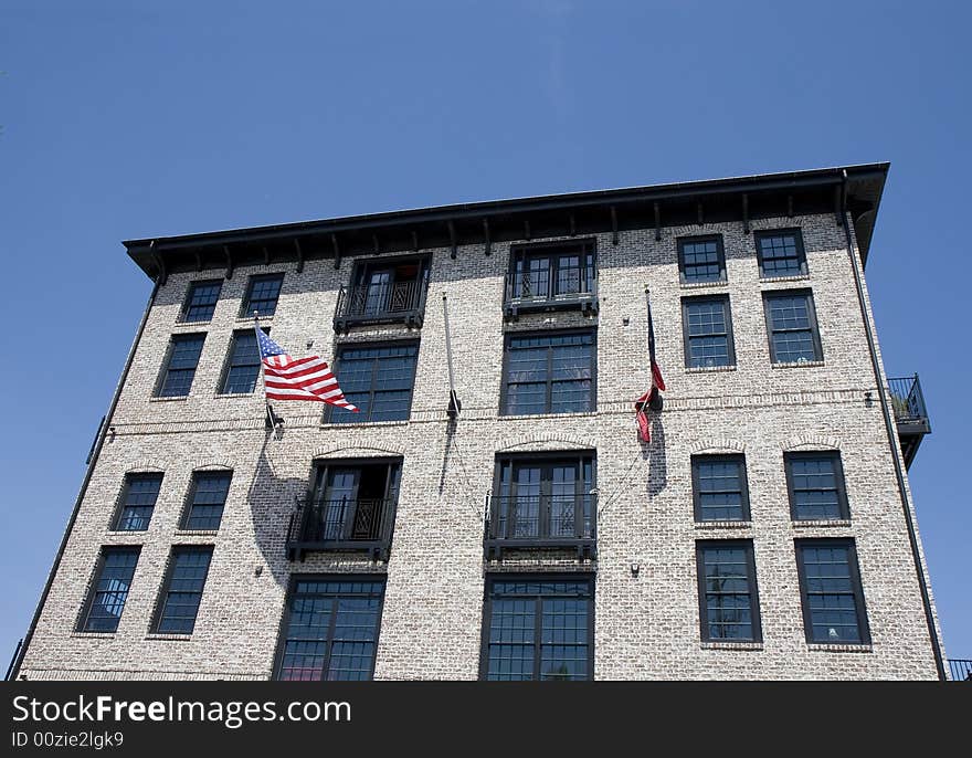 Modern loft building in a classic architecture style with american flags out front. Modern loft building in a classic architecture style with american flags out front