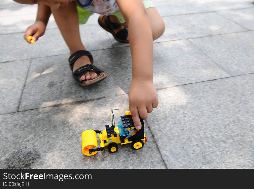 The Boy Playing A Toy Vehicle