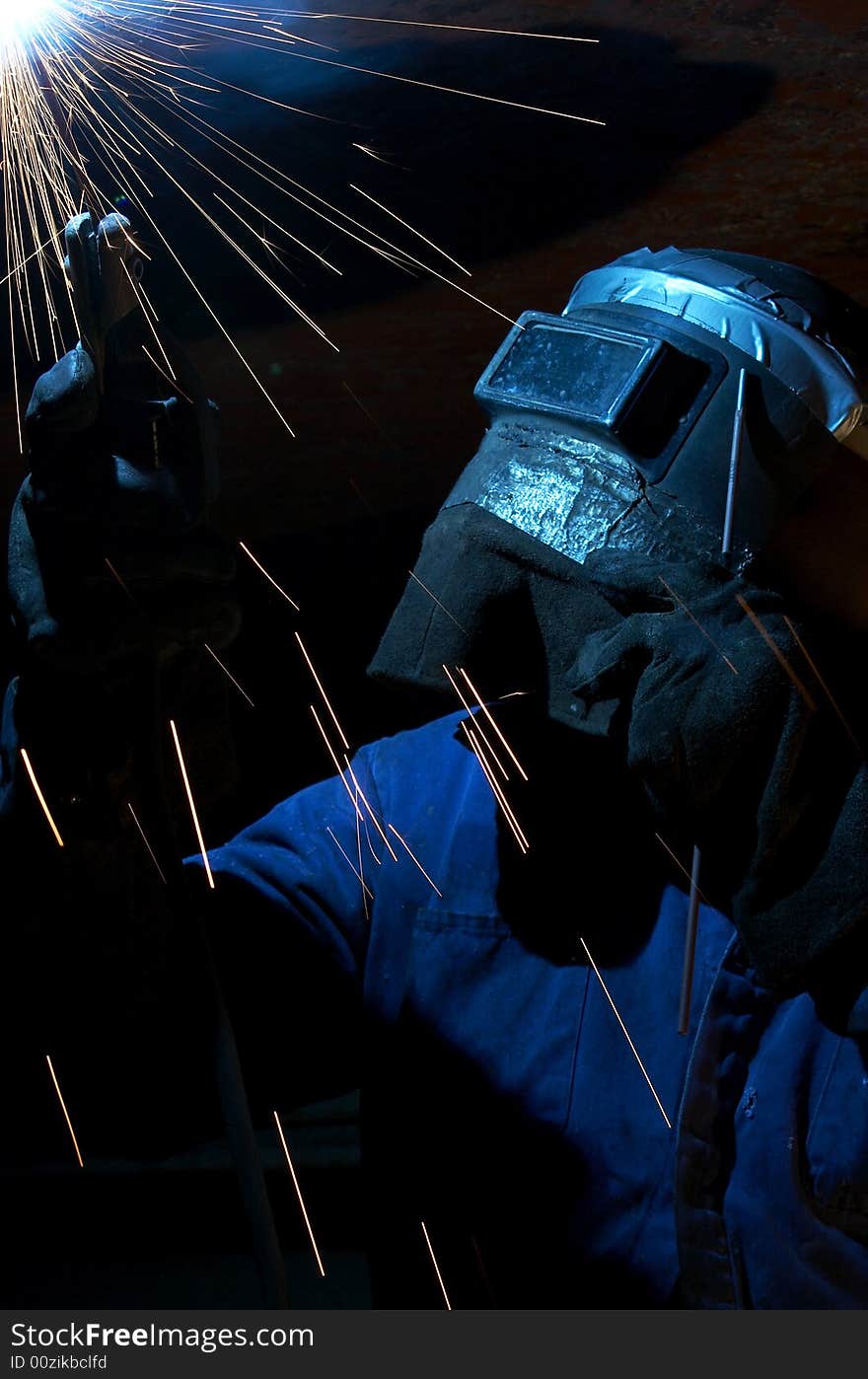 A welder working at shipyard at night. A welder working at shipyard at night