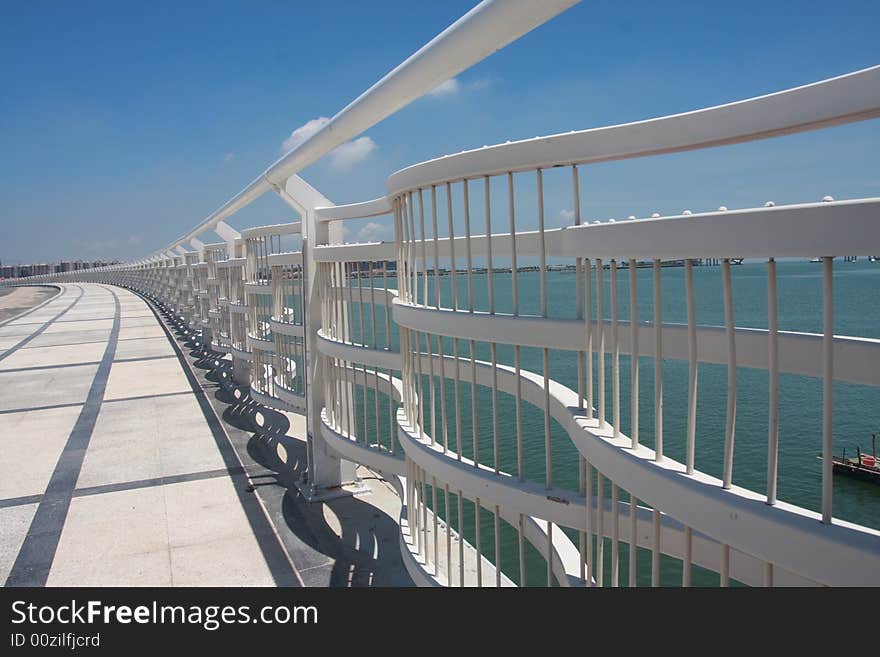 White railing of a new arcing bridge. White railing of a new arcing bridge