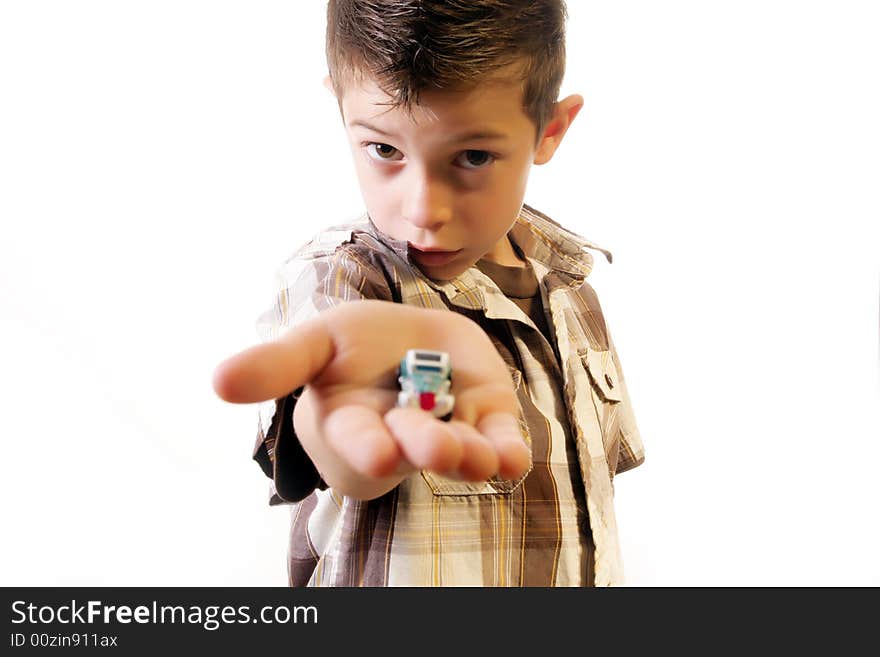 Six year old boy offering one of his toy. Six year old boy offering one of his toy