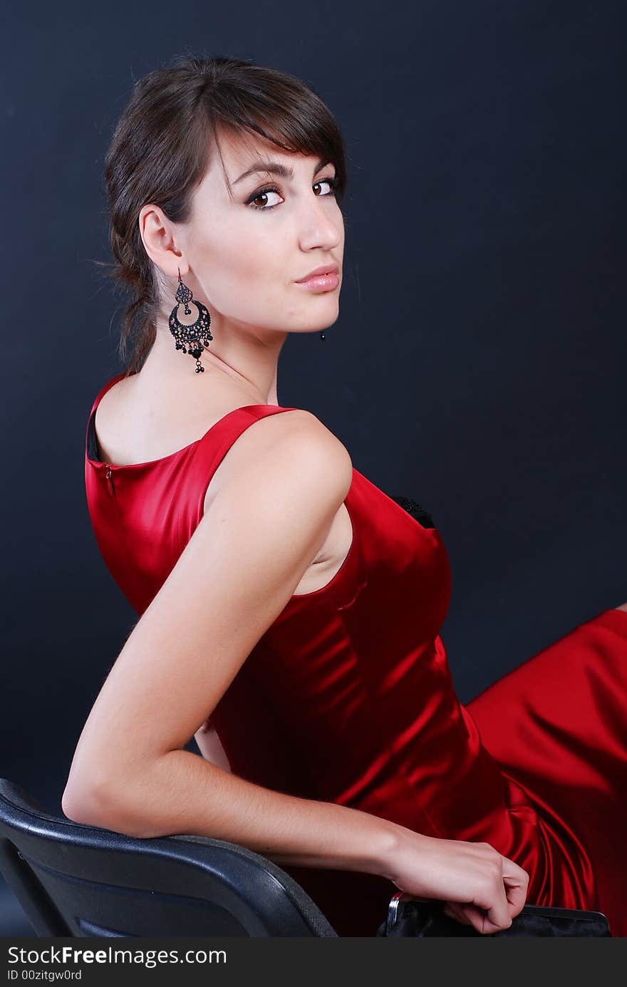 A beautiful young girl is dressed in red clothes with the Dorothy bag in hands. A beautiful young girl is dressed in red clothes with the Dorothy bag in hands