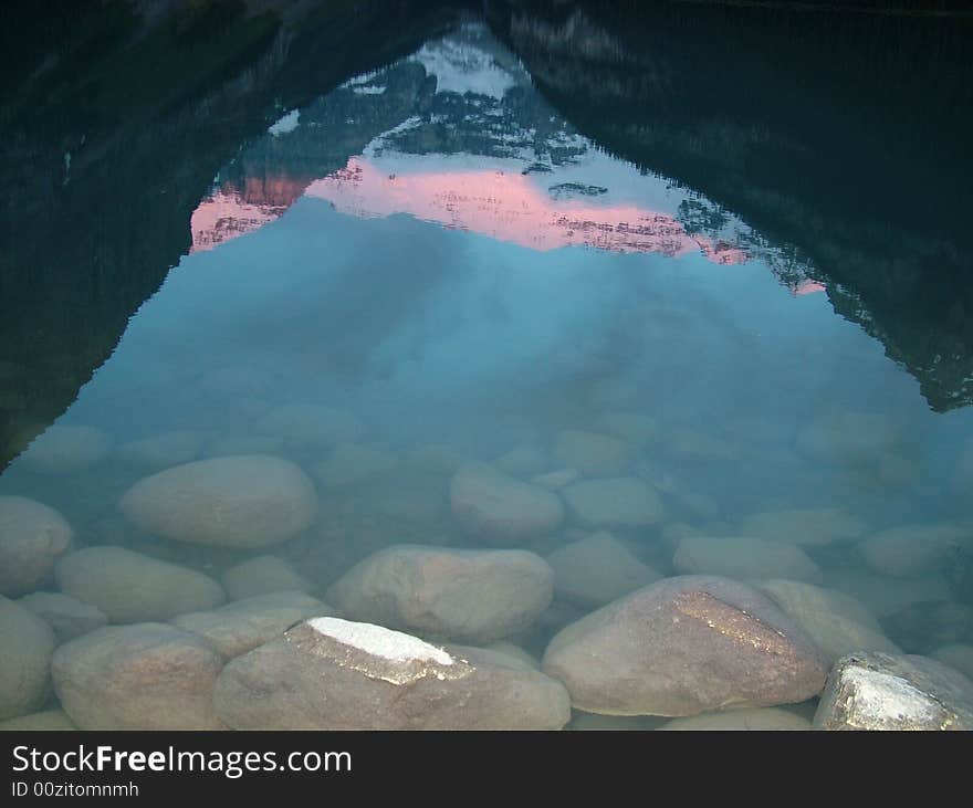 Sunrise over Lake Louise shown in the waters reflection, The Rockies, Canada. Sunrise over Lake Louise shown in the waters reflection, The Rockies, Canada