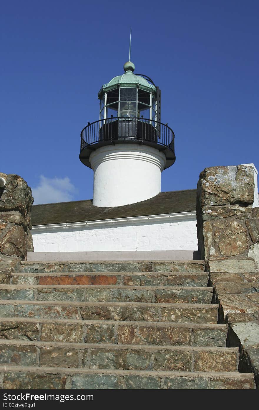 View of Old Point Loma Lighthouse tower from stone steps on hill below. View of Old Point Loma Lighthouse tower from stone steps on hill below