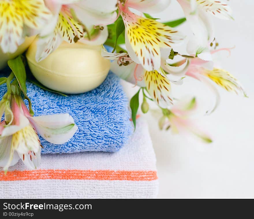 Soap and flower on blue fabric background for your design