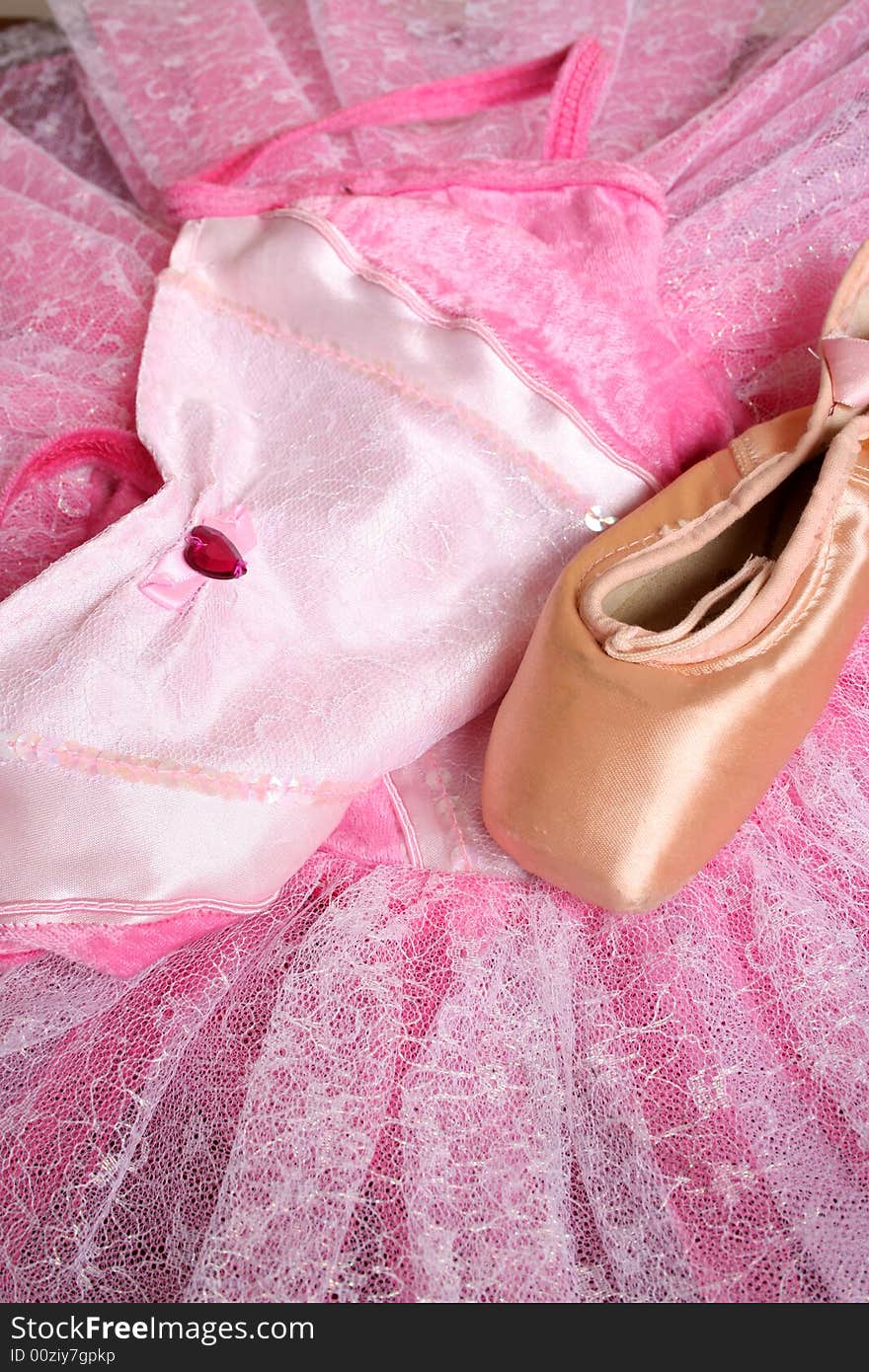 Pink Ballet costume and a used ballet shoe