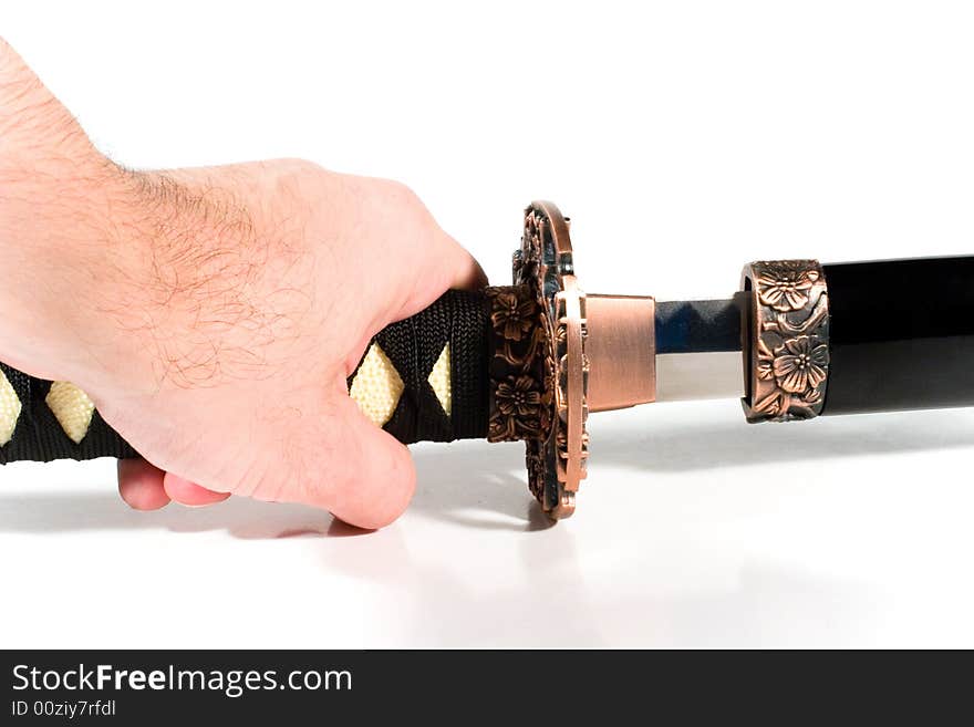 Hand pulling out a Japanese sword from the sheath (on white background). Hand pulling out a Japanese sword from the sheath (on white background)