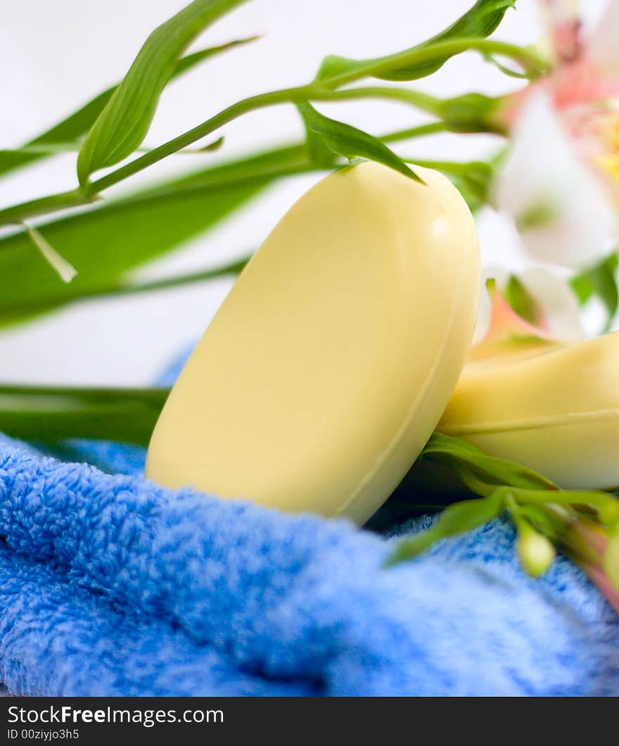 Soap and flower on blue fabric background