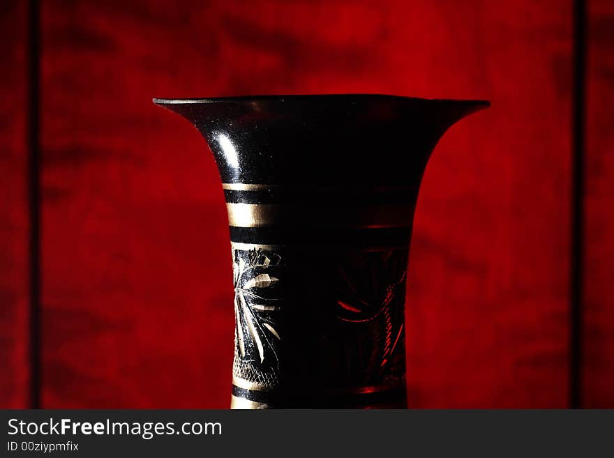 Vintage vase on wood background (focus on vase).