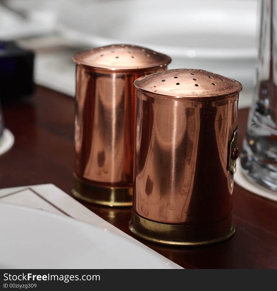 Saltcellar and Pepper Pot on Wood Table. Saltcellar and Pepper Pot on Wood Table