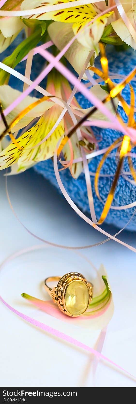 Flowers on blue fabric background and jewelry