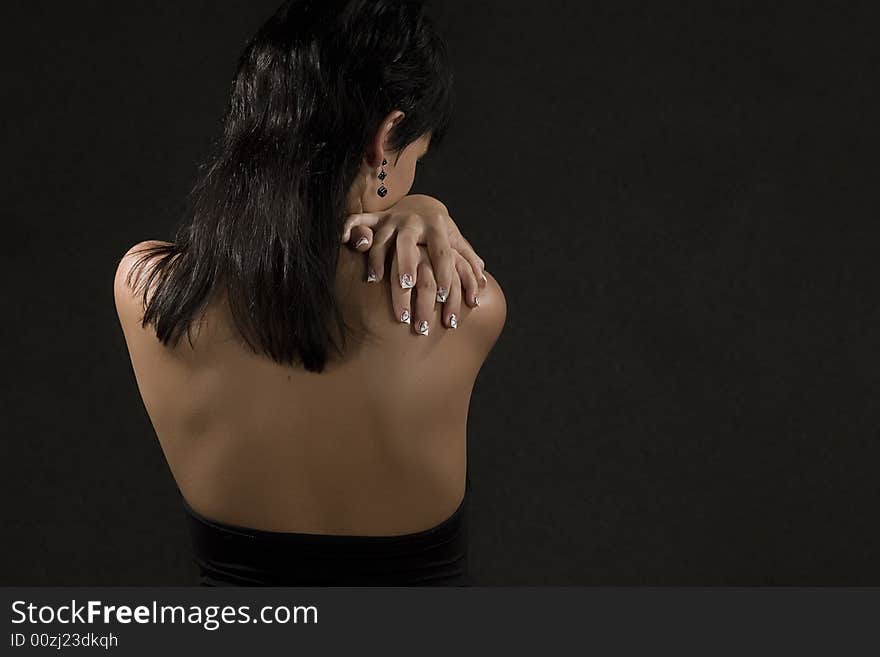 Beautiful young girl back portrait on black background. Beautiful young girl back portrait on black background