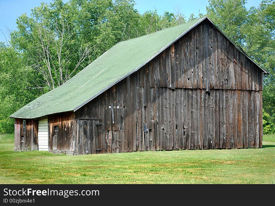 Old dilapidated barn in summer. Old dilapidated barn in summer.