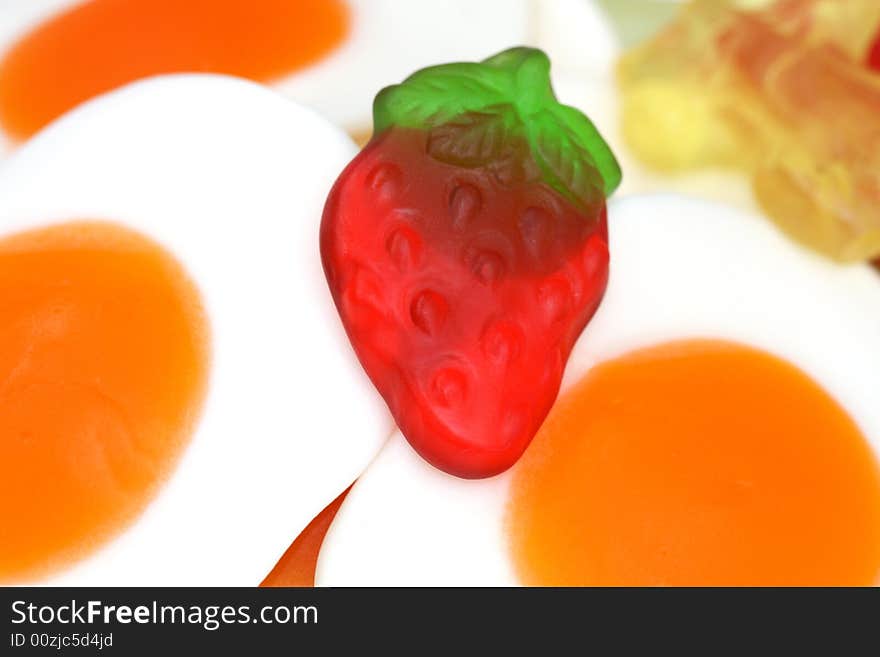 Gummi fryed eggs  and strawberry close up. Gummi fryed eggs  and strawberry close up