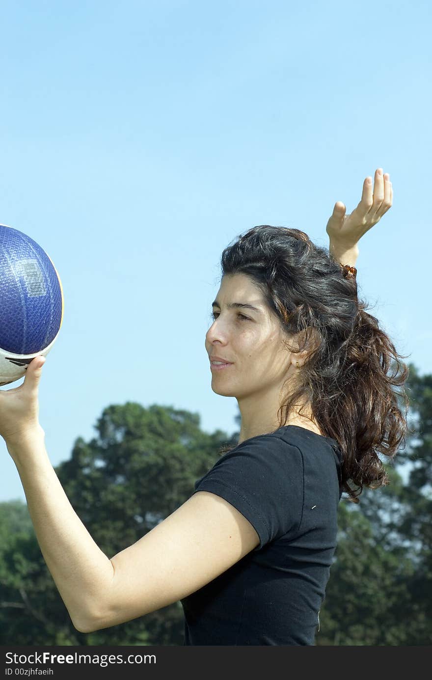 Woman Spiking Volleyball - Vertically framed shot.