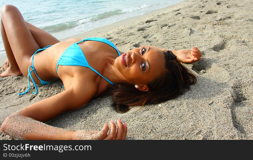 Young black woman in a bikini at the beach. Young black woman in a bikini at the beach.