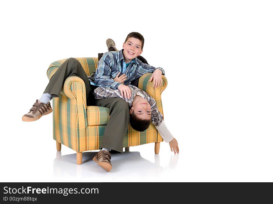 Two young happy smiling boys playing in the chair. Two young happy smiling boys playing in the chair