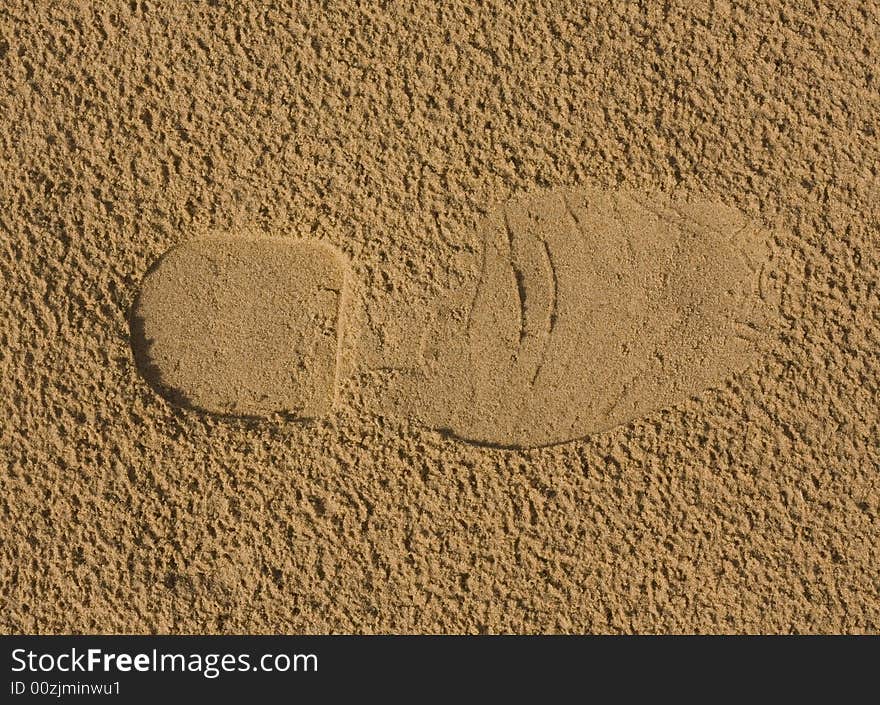 Footprint on sand after rain