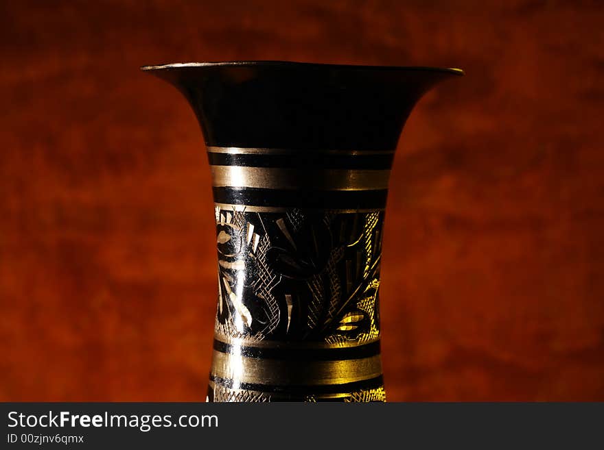 Vintage vase on wood background (focus on vase).