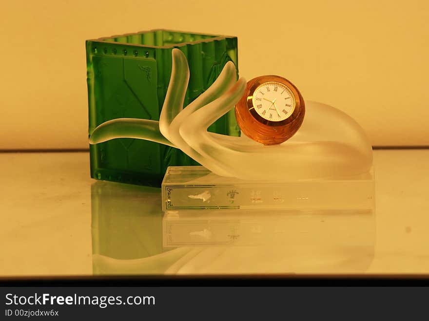 Crystal Cup, Clock And Hand On The Table