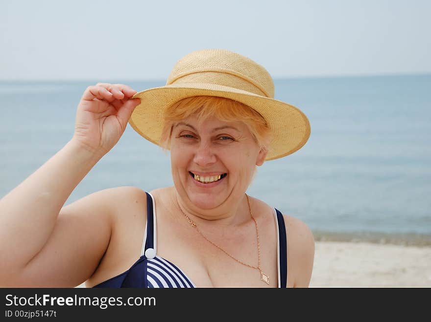 Woman in hat on sea background