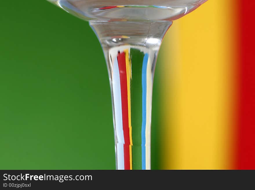 A glass with a simple green - yellow - red - blue color background. A glass with a simple green - yellow - red - blue color background