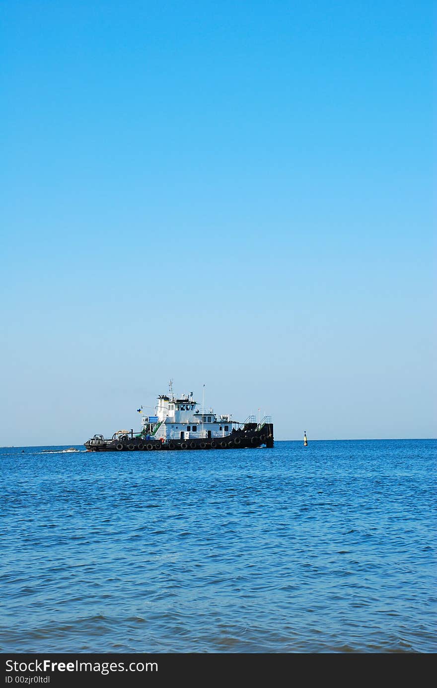 Tugboat go to sea over blue sky