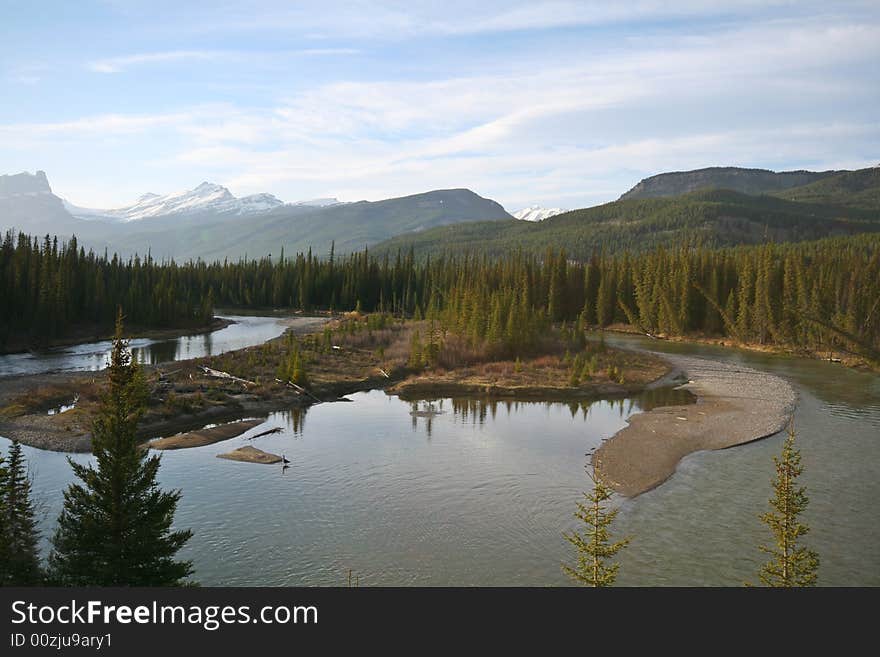 River in a wide valley among high mountains. River in a wide valley among high mountains.